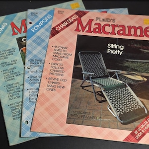 May include: Three vintage macrame craft books. Titles include "Chairs", "Pompons", and "Plaid's Macrame". The "Plaid's Macrame" book features a chair with a macrame seat. The covers have plaid patterns and text.