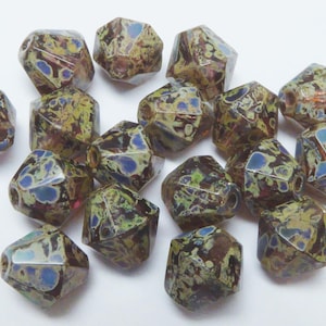 May include: A selection of faceted beads in various colours. The beads feature a distinctive pattern with brown, green, blue, and yellow hues. These beads are suitable for jewellery making and craft projects.