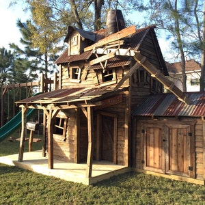 May include: A wooden playhouse with a rusty metal roof, a green slide, and a sign that reads "General Store".