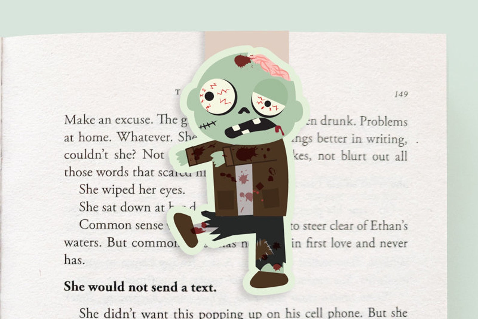 An open book with a bookmark of a green zombie walking