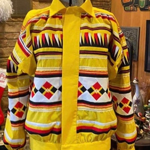 May include: A yellow button-up shirt with a geometric pattern in red, black, white, and yellow. The shirt has a collar and long sleeves.
