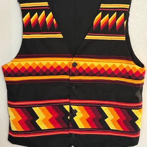 May include: A black vest with a V-neck and button closure. The vest features colorful geometric patterns in red, yellow, and orange. The patterns are arranged in horizontal and vertical bands, creating a striking visual contrast.