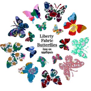 May include: A collection of various butterfly-shaped iron-on fabric appliques featuring diverse floral and geometric patterns in colors including red, blue, green, pink, and yellow. The text Liberty Fabric Butterflies iron-on appliques is centered.