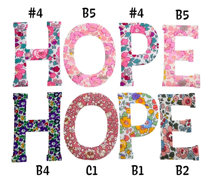 May include: Eight fabric letters spelling the word HOPE twice, arranged in two rows. The letters feature various floral patterns in pink, purple, yellow, and blue. Each letter is labeled with a code such as #4, B5, B4, C1, B1, or B2.