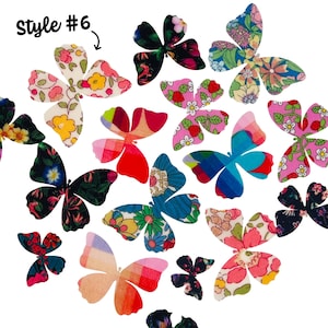 Puede incluir: Una colección de mariposas de tela coloridas con diseños florales y estampados. Las mariposas son de varios tamaños y colores, incluyendo rosa, azul, verde y rojo. El texto "Style #6" es visible en la esquina superior izquierda.