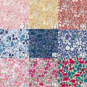 May include: A grid of nine fabric swatches featuring dense floral patterns in various colourways, labelled 20 through 28. The designs include pink, yellow, red, blue, and multi-coloured botanical prints with intricate stems and small blossoms.