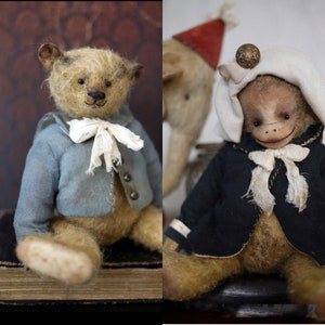 May include: Two handmade plush toys, a brown teddy bear wearing a blue jacket and a brown monkey wearing a navy blue jacket. Both toys have white collars and are sitting on a wooden surface.