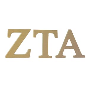 May include: Three wooden letters spelling out "ZTA" in a light brown color. The letters are in all caps and are about 4 inches tall.