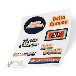 May include: A sheet of stickers featuring various designs for Delta Gamma sorority. The stickers feature the sorority name in different fonts and colors, including a retro-style design with the letters "DG" in a rectangle. The stickers also include the sorority's founding year, 1873.