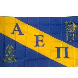 May include: A blue and gold fraternity flag with the letters A E II and a crest with a menorah and the words "E. Zichron" in the lower left corner. A lion holding a staff is in the upper right corner.