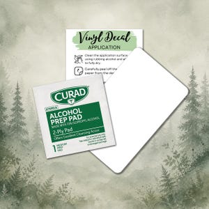 May include: An image featuring a white vinyl decal application card, a Curad alcohol prep pad, and a white card. The alcohol prep pad is green and white, with text that reads "Alcohol Prep Pad". The vinyl decal application card has instructions.