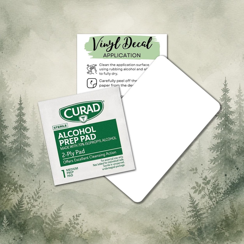 May include: An image featuring a white vinyl decal application card, a Curad alcohol prep pad, and a white card. The alcohol prep pad is green and white, with text that reads "Alcohol Prep Pad". The vinyl decal application card has instructions.