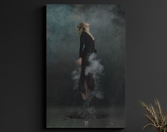 May include: A woman in a black dress stands in a cloud of smoke, looking upwards. The background is a dark blue and green color with a textured effect. The image has a surreal and ethereal feel.