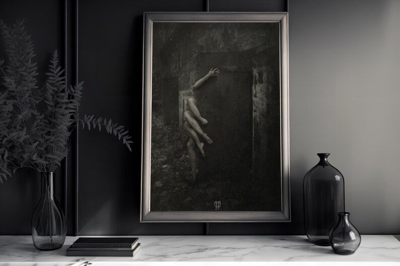 May include: A framed black and white photograph of a person's legs reaching out from a dark doorway. The image has a vintage, distressed look.
