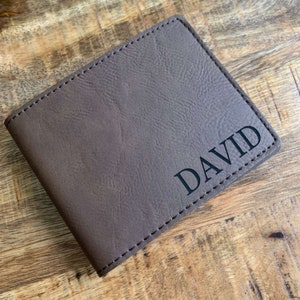 May include: A brown leather wallet with the name "DAVID" embossed in black lettering.