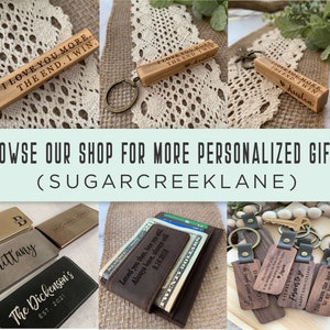 May include: A collection of personalized gifts, including wooden keychains with engraved messages, leather wallets with custom monogramming, and wooden keychain blocks with engraved messages. The text on the keychains includes "I love you more. The end. I win." and "You have the keys to my heart."