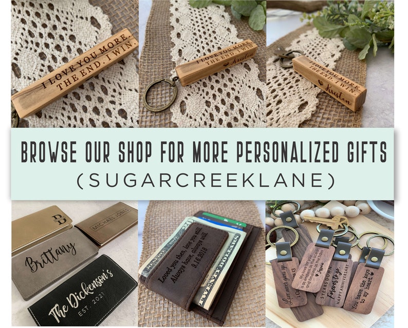 May include: A collection of personalized gifts, including wooden keychains with engraved messages, leather wallets with custom monogramming, and wooden keychain blocks with engraved messages. The text on the keychains includes "I love you more. The end. I win." and "You have the keys to my heart."