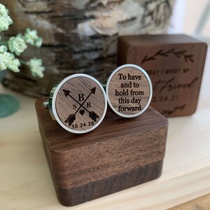 May include: A pair of wooden cufflinks in a wooden box. One cufflink has the text "To have and to hold from this day forward" and the other cufflink has the initials "S & R" with arrows and a heart and the date "10.24.20".