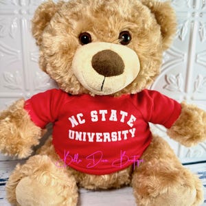 May include: A rustic wooden sign with the text "Welcome to our home" in a handwritten style. The sign is rectangular, with a distressed finish, and features a simple, inviting design. It's likely intended for indoor or outdoor home decor.