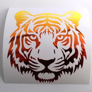 May include: A tiger head sticker with a gradient design, transitioning from yellow to orange and red. The sticker features detailed lines and a fierce expression, suitable for various applications.