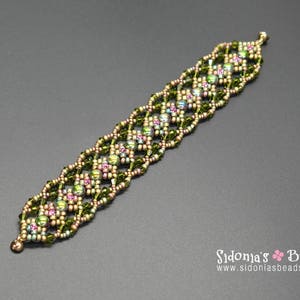 May include: A green and gold beaded bracelet with a geometric pattern. The bracelet is made with small seed beads and features a subtle iridescent sheen.