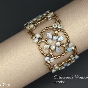 May include: A delicate bracelet made with small, iridescent blue and white beads, woven into a floral pattern with gold accents. The bracelet is worn on a person's wrist.  Catherine's Windows Bracelet tutorial.