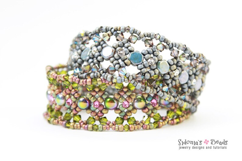 May include: Three beaded bracelets stacked on top of each other. The top bracelet is silver with a geometric pattern. The middle bracelet is brown with a geometric pattern. The bottom bracelet is green with a geometric pattern.
