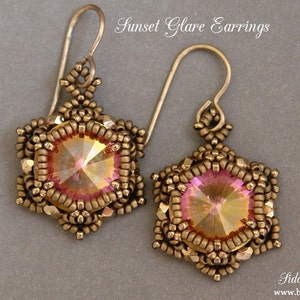 May include: A pair of gold-toned earrings featuring a pink and gold iridescent gemstone at the centre of each earring. The earrings are crafted with small beads and have a delicate, intricate design.