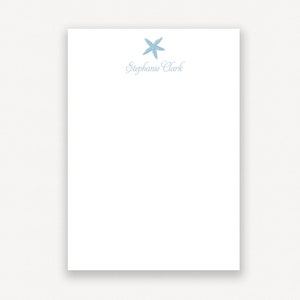 May include: A white notepad with a blue starfish and the text "Stephanie Clark" printed at the top.