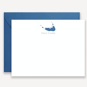 May include: A white stationery card with a blue outline of an island and the text "Sally Clark" printed in blue.