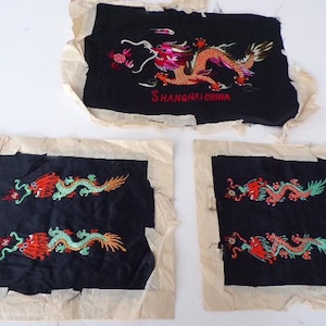 May include: Three black fabric panels with embroidered red and green dragons. The panels have white borders and the text "SHANGHAICHINA" is embroidered on the top panel.