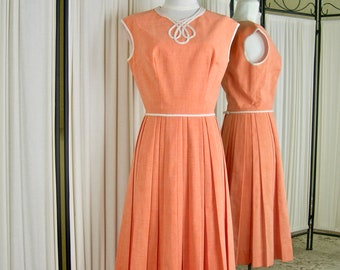 Vintage Summer dress, 1960's, tangerine cotton blend, sleeveless, pleated skirt, detailed at neck, armscye, waist with bias tape, size 8