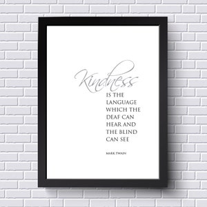 May include: A black framed print with a white background and a quote about kindness. The quote reads "Kindness is the language which the deaf can hear and the blind can see." The quote is attributed to Mark Twain.