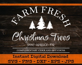 May include: A white sign with the text "FARM FRESH Christmas Trees PINE SPRUCE FIR COMPLIMENTARY CIDER AND HOT COCOA" on a dark brown wood background. The sign also features a silhouette of three Christmas trees.