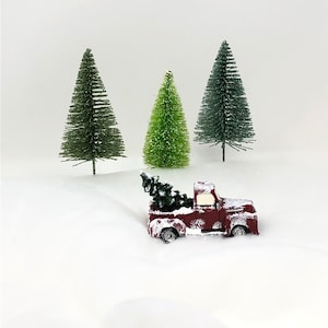 Larger Snow-Covered Miniature Christmas Red Pickup Truck with a Christmas Tree