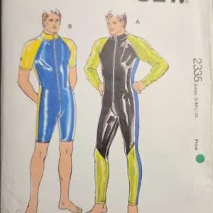 May include: A Kwik Sew pattern envelope 2335 for sizes S-M-L-XL featuring illustrations of two athletic jumpsuits. One is a blue and yellow short-sleeve, short-leg suit, and the other is a black, blue, and yellow long-sleeve, long-leg suit.
