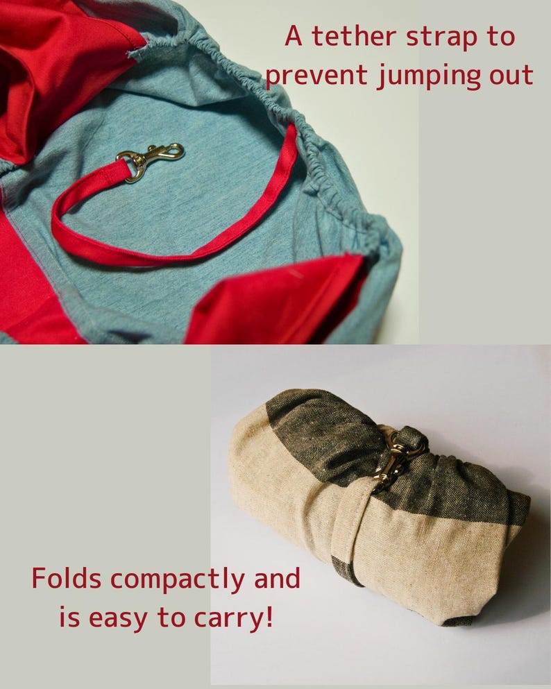 Op de afbeelding: Een lichtblauwe en rode stoffen baby draagzak met een bevestigingsband en een metalen sluiting. De draagzak is opgevouwen en vastgemaakt met de band. De tekst "A tether strap to prevent jumping out" en "Folds compactly and is easy to carry!" is zichtbaar in de afbeelding.