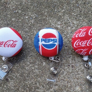 Porta credenciales de tela Coca Cola Pepsi con pinza de cocodrilo