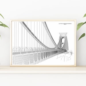 Könnte beinhalten: Ein Schwarzweiß-Linienzeichnung-Druck der Clifton Suspension Bridge in Bristol, England. Der Druck ist in einem hellen Holzrahmen gerahmt und hängt an einer weißen Wand.