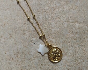 Gold chain necklace with angel and star medallion