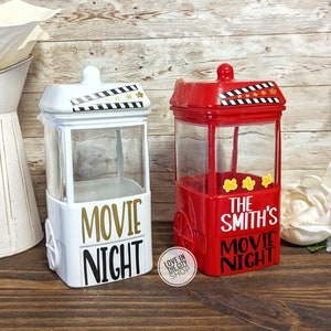 May include: Two popcorn containers, one white and one red, with the text "Movie Night" on the front. The red container has the text "The Smith's" above the text "Movie Night".