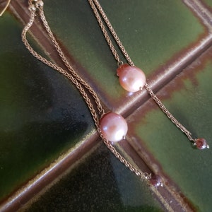 Faceted cinnamon diamonds and glowy pearls dangle to a shoulder brushing 5 inches on doubled gold rope chain to swing light and bright!