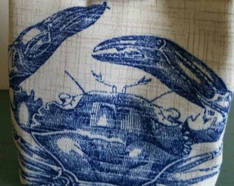 Feelin&#39; Crabby Trio Bag is an uniquely shaped, wrist-strap bag in seaworthy colors; the blue crab and nautilus shell add to the attraction!