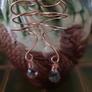 Corkscrew Earrings are freeform coils of rose gold, 4 inches from rose gold French earwires to wrapped mystic rock crystal quartz briolettes
