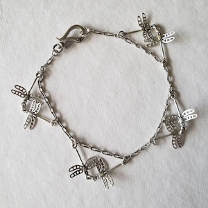 Silver Dragonflies Charm Bracelet pairs hovering sterling dragonflies on textured oxidized silver chain to drape enticingly on your wrist!