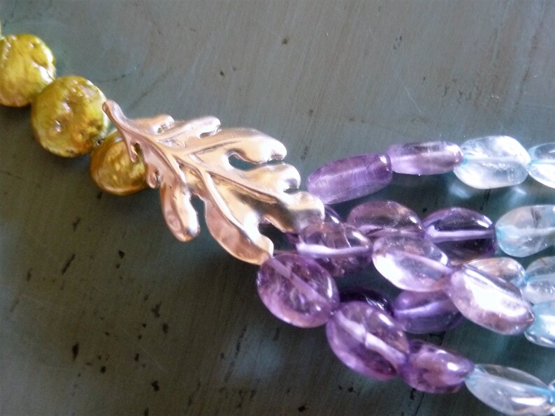 Soft Dreams Necklace is 5 strands of pastel oval gems gathered into brushed silver oak leaves and coin pearls and secured by a silver toggle