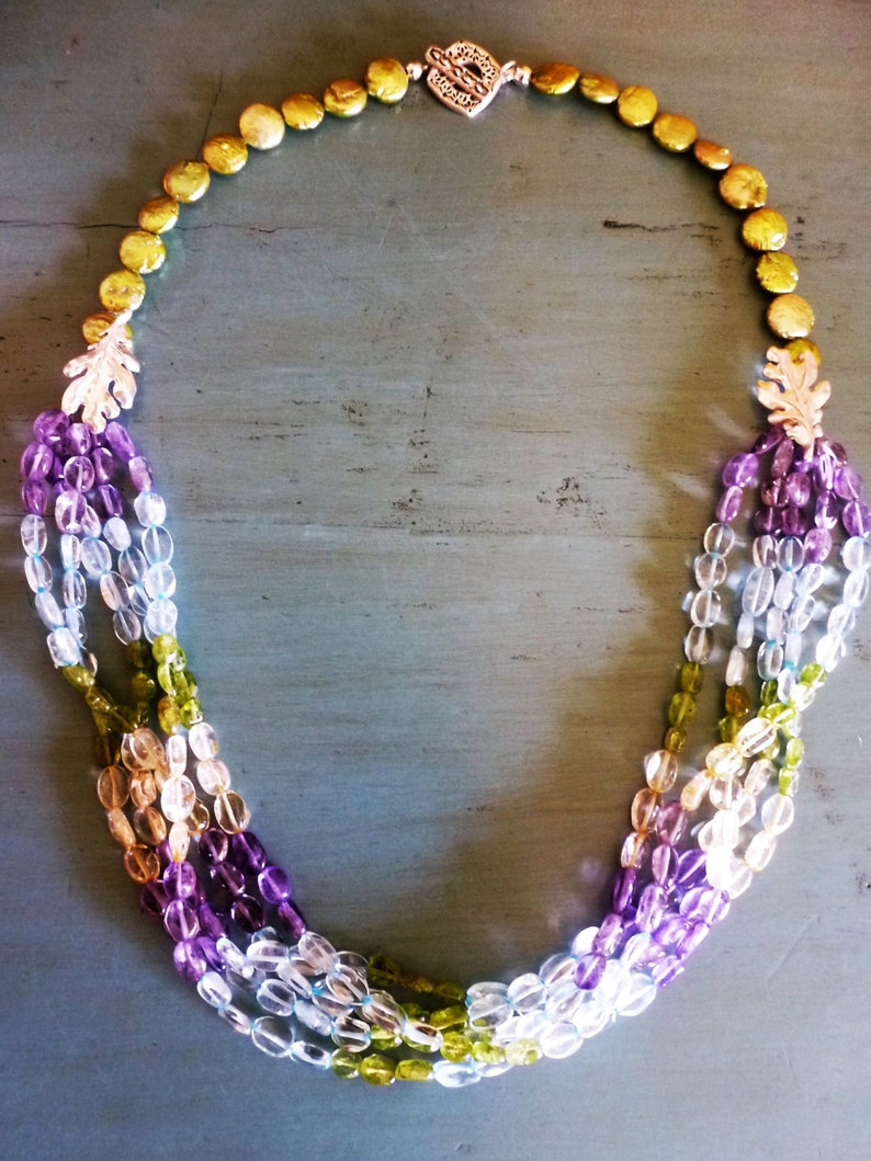 Soft Dreams Necklace is 5 strands of pastel oval gems gathered into brushed silver oak leaves and coin pearls and secured by a silver toggle