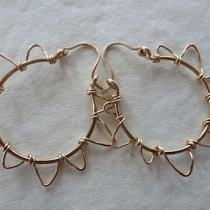 Hammered gold freeform rays wrap onto hoops of Sunshine on My Shoulders Earrings. Simple...and a bit Avant Garde.