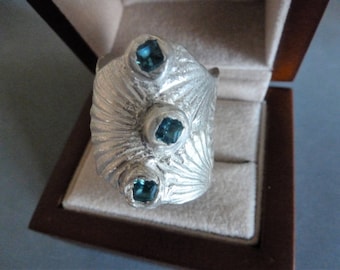 Scallop Shell Shield Ring - 28 grams of solid fine silver in size 10, beautifully wrapped and studded with lab-created London Blue Topaz.