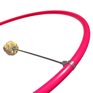 May include: A pink fire hoop with a rope wick attached to a metal rod. The hoop is made of a flexible material and is designed for fire dancing.
